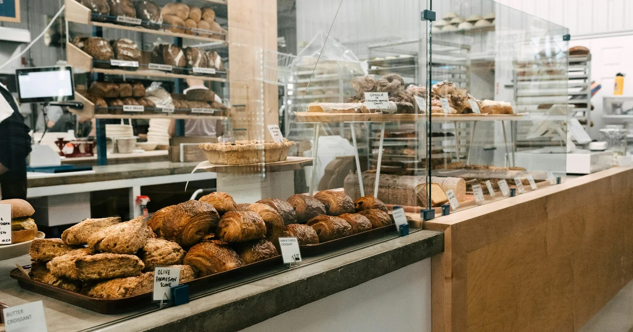 Bakery counter stacked with croissants, scones and loaves ready for holiday pickup orders